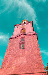 Low angle view of clock tower against sky in city