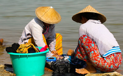 Women cleaning clothes at riverbank