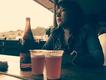 Woman drinking glass on table