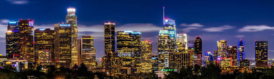 Illuminated cityscape against sky at night