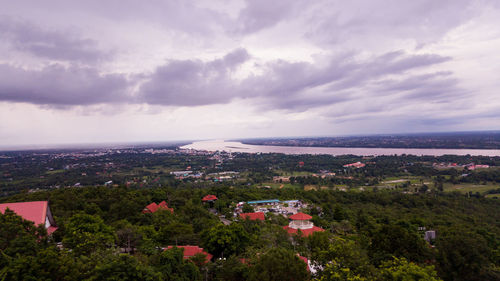 High angle view of townscape by sea against sky