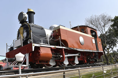 Low angle view of train on railroad tracks against clear sky