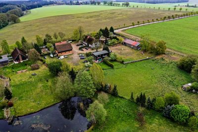 High angle view of agricultural field by buildings