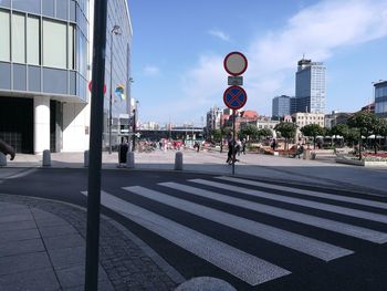 Road signs in city against sky