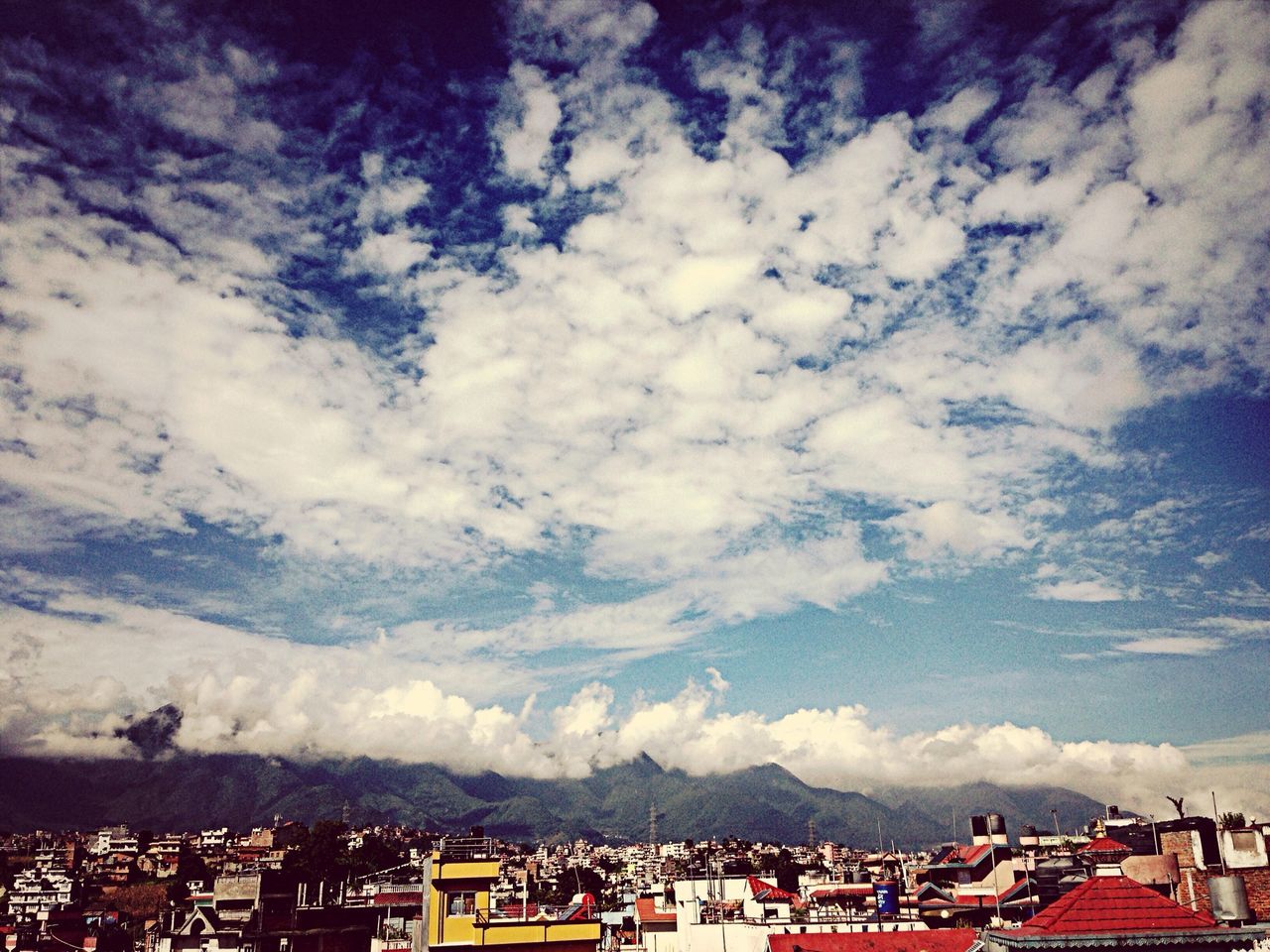 sky, building exterior, cloud - sky, built structure, mountain, architecture, cloudy, cloud, house, mountain range, roof, scenics, nature, landscape, residential structure, weather, day, beauty in nature, outdoors, town