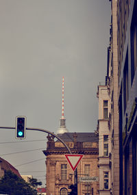 Low angle view of road signal against sky