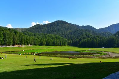 Scenic view of golf course against sky