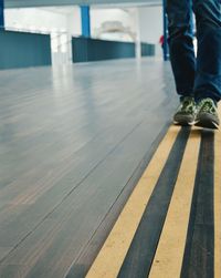 Low section of man standing on floor