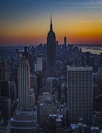 Aerial view of buildings in city during sunset