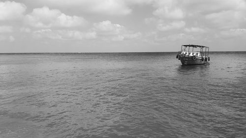 Scenic view of sea against cloudy sky