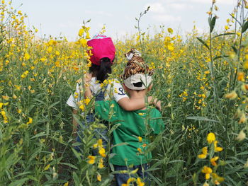 Young woman with yellow flowers in field