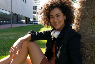 Portrait of smiling woman sitting outdoors