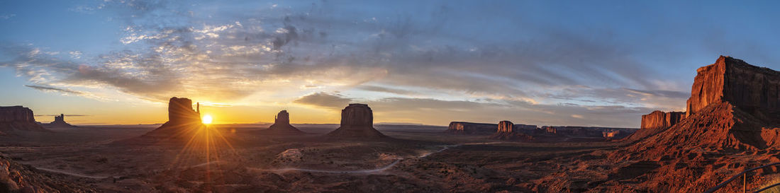 Panoramic view of rock formations against sky during sunset