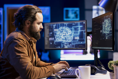 Side view of man working at office