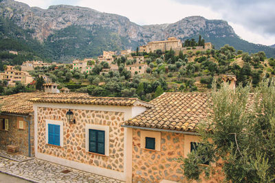 View of houses against rock mountain