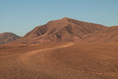 Scenic view of desert against clear sky