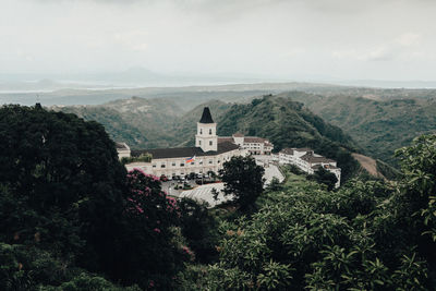 High angle view of trees and buildings against sky