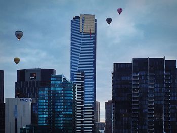 Low angle view of buildings against cloudy sky