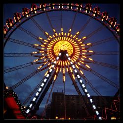 Low angle view of ferris wheel against sky