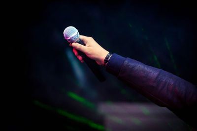 Close-up of hand holding microphone