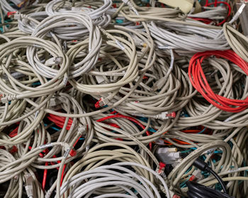 Old it network cables and power cables stored in a lattice box for disposal