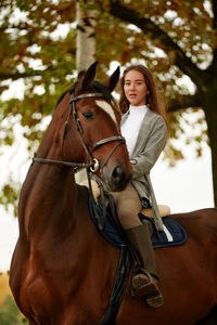 Portrait of young woman riding horse