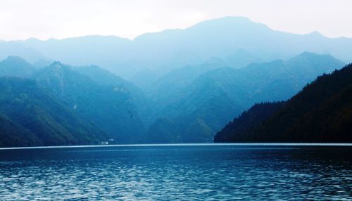 Scenic view of mountains against blue sky