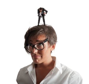 Portrait of young man standing against white background