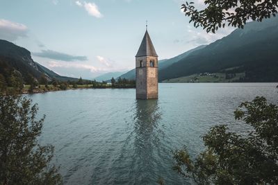 View of lake by building against sky