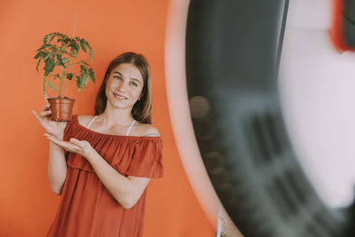 Portrait of a smiling young woman drinking glass