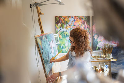 Artist painting in studio