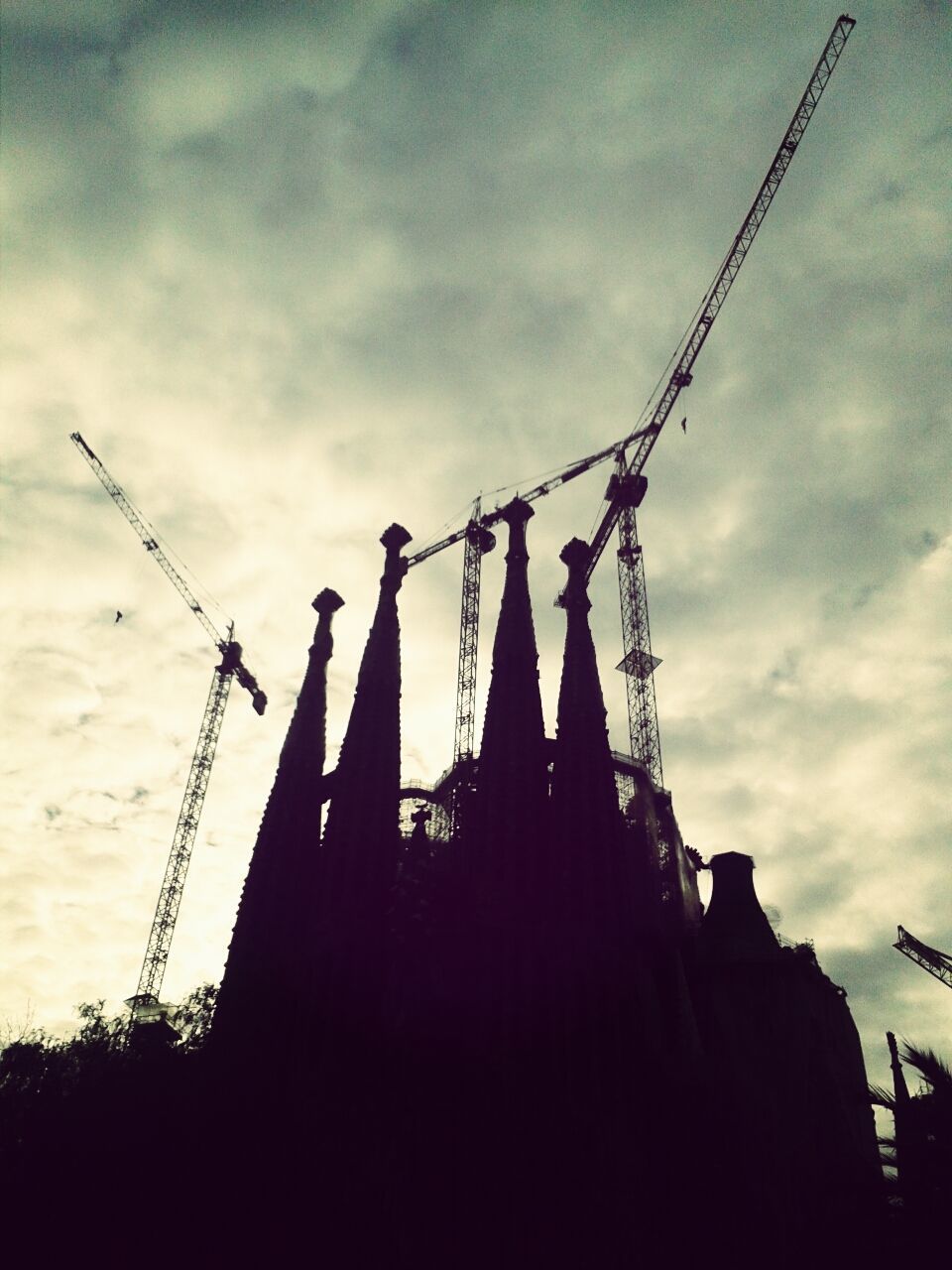 architecture, built structure, sky, low angle view, building exterior, cloud - sky, silhouette, religion, cloudy, place of worship, spirituality, cloud, dusk, fuel and power generation, outdoors, traditional windmill, crane - construction machinery, no people, windmill