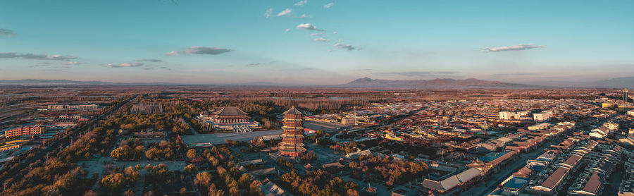 Aerial view of cityscape against sky during sunset