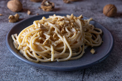 Spaghetti with walnut cream. nutritious dish suitable for those who follow a vegetarian diet.