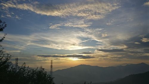 Low angle view of silhouette mountains against sky at sunset