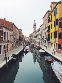 Boats in river with buildings in background