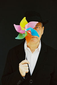 Portrait of a man holding a pinwheel 