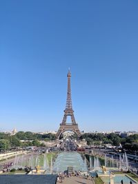 Buildings in city against clear blue sky