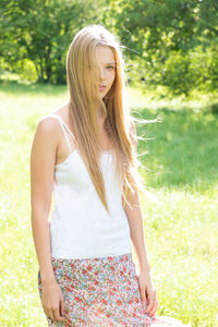 Portrait of beautiful teenage girl standing on field