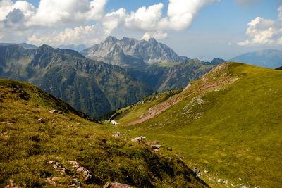 Scenic view of mountains against cloudy sky