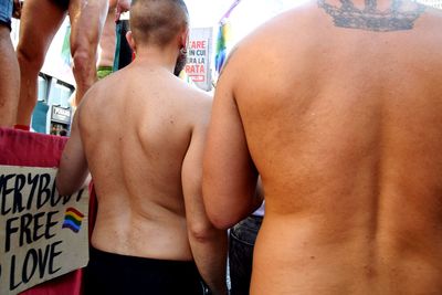 Rear view of shirtless man standing outdoors