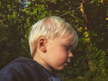 Low angle view of cute boy looking down