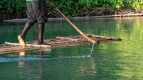 Punting down a river on a bamboo raft