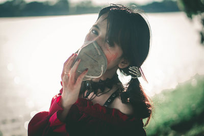 Portrait of young woman holding umbrella