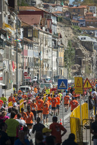 Crowd running on street during marathon in town