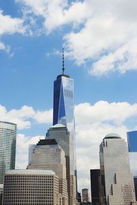 Low angle view of modern buildings against cloudy sky