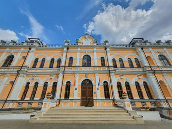 Low angle view of building against cloudy sky