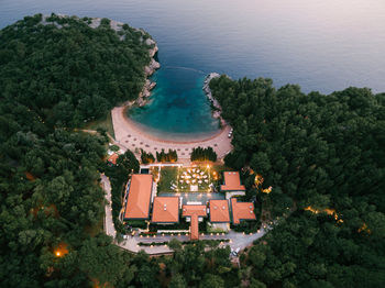 High angle view of illuminated building by sea