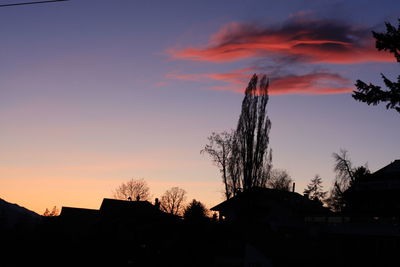 Low angle view of silhouette buildings against sky at sunset