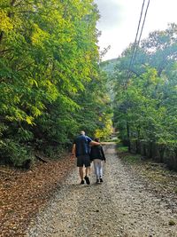 Rear view of woman walking in forest